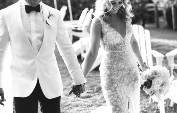 beautiful couple holding hands after wedding - black and white photo