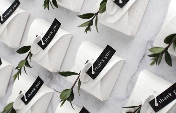White paper bags with black labels on a table.