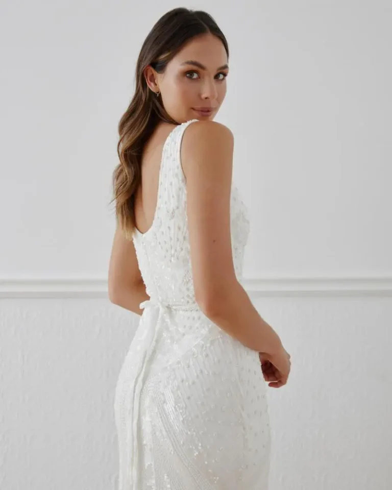 a bride looking back toward the camera in a wedding dress for short brides