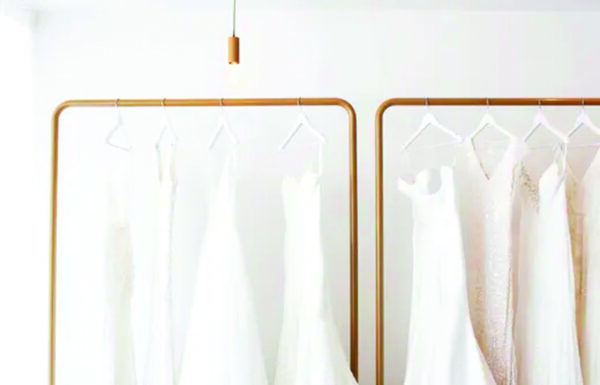 selections of bridal gown hanging in a wedding dress shop