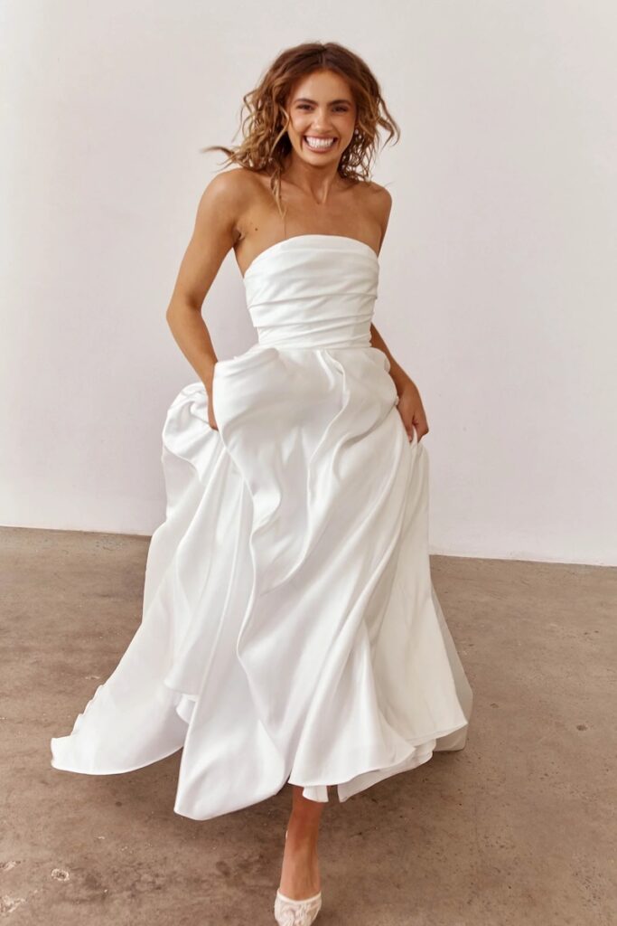 A bride running in an a line wedding dress