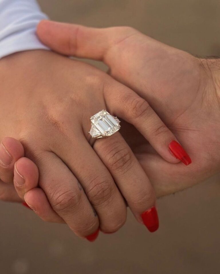 Demi Lovato and her boyfriend holding hands with her engagement ring on
