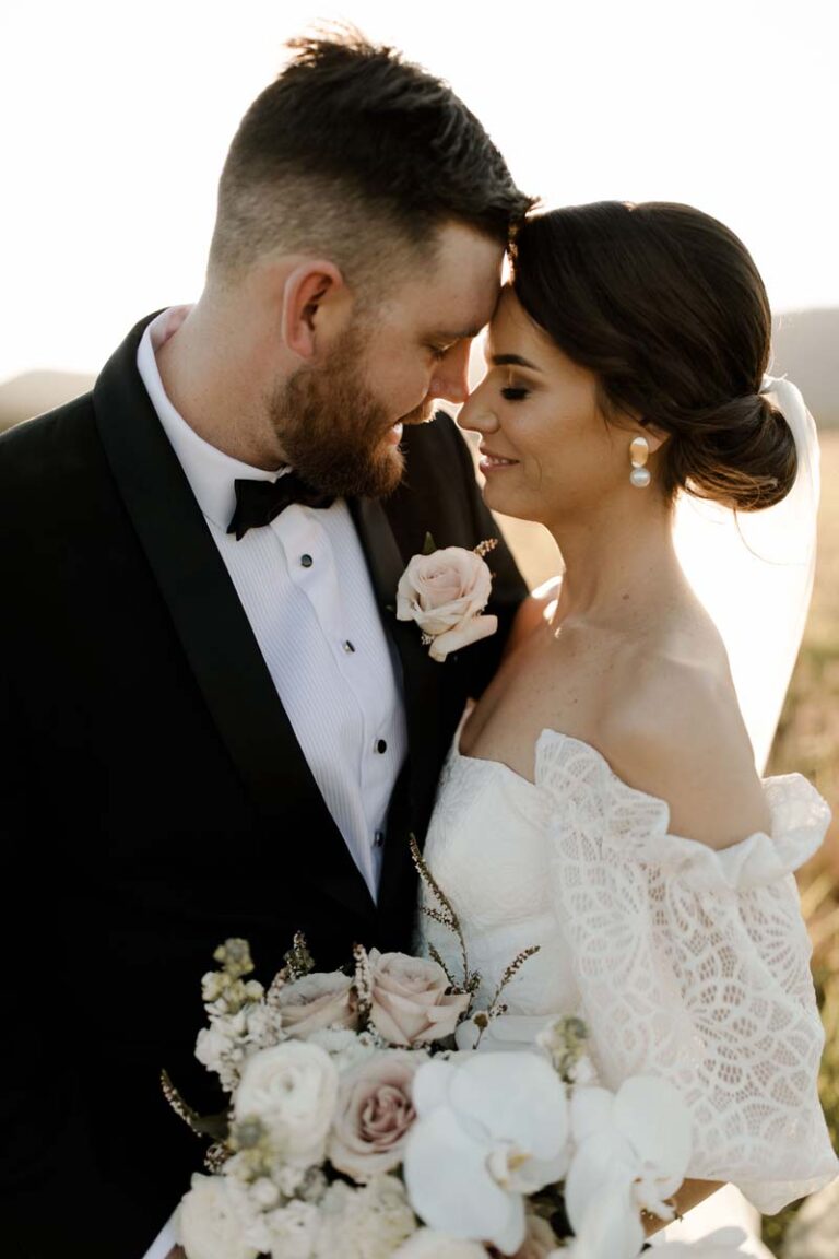 the bride and groom looking at each other endearingly