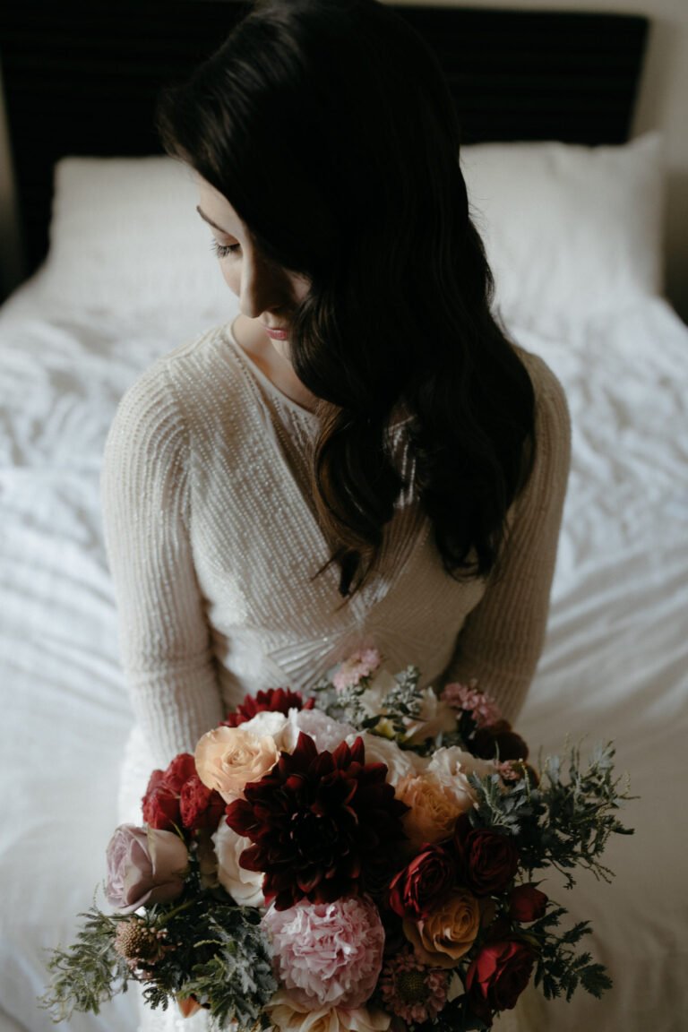 the bride holding a colorful bouquet of flowers