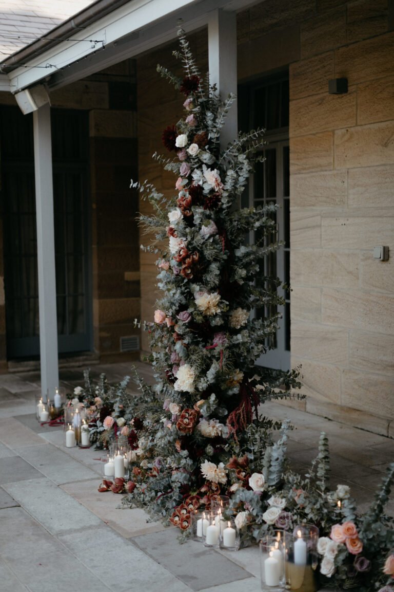 a beautiful arrangement of flowers and candles placed neatly on the floor