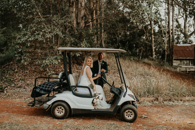 a married couple inside a golf cart at their wedding