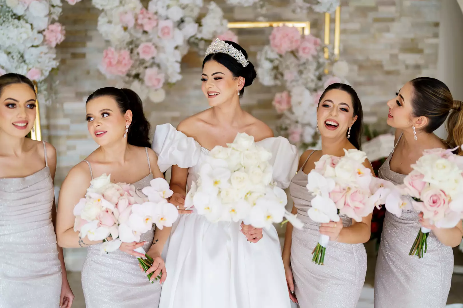 Bride and bridesmaids in white dresses holding pink bouquets from Lush Flower Co, one of the best wedding florists in Sydney.