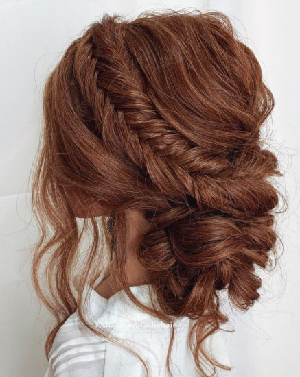 a photo of a woman with a big-textured bun hairstyle
