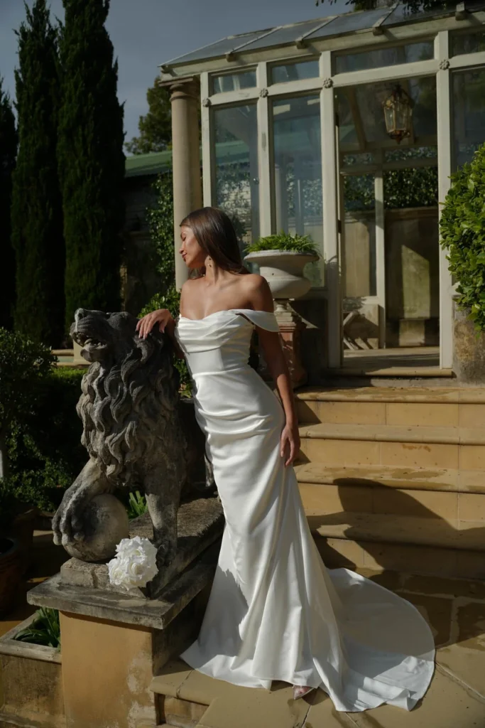 A bride wearing an off shoulder cheap wedding dress under $500