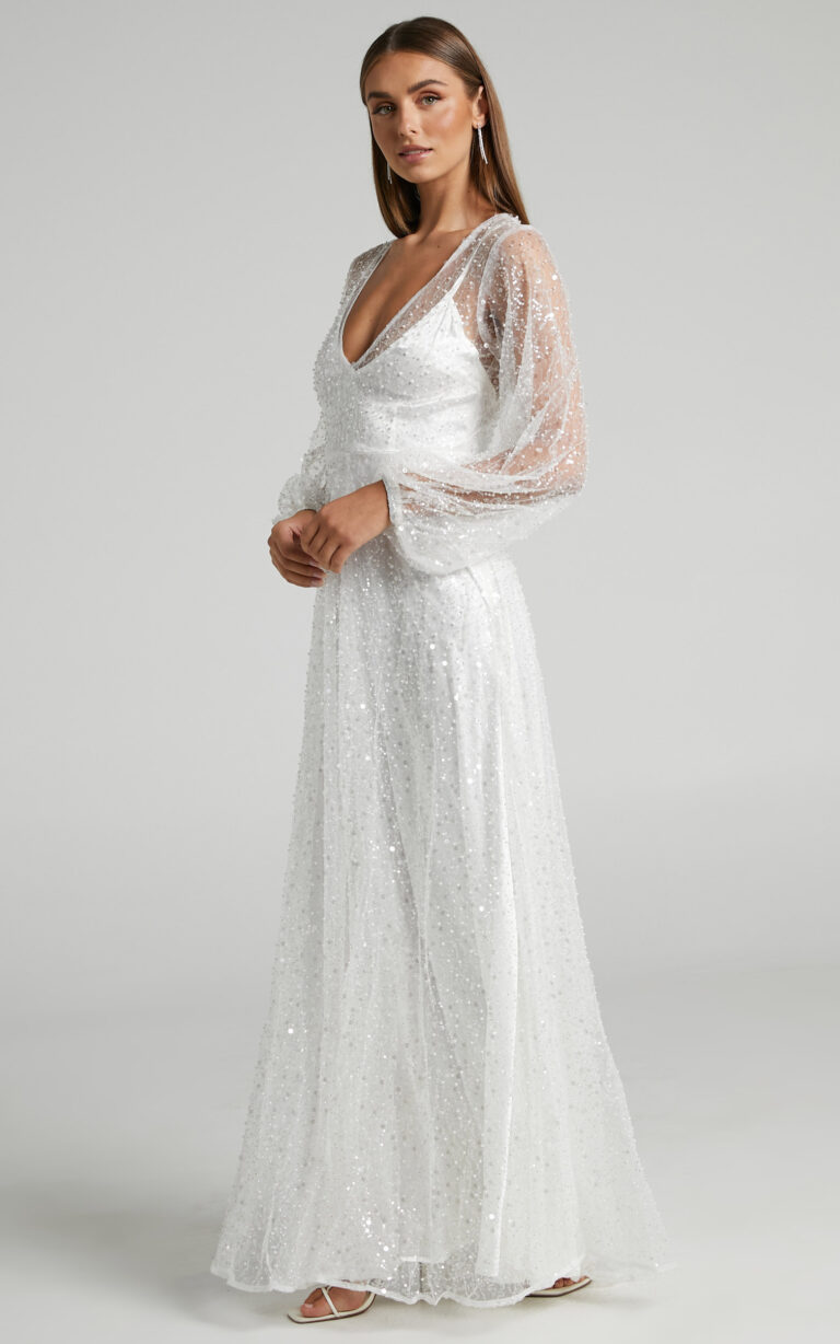 Bride wearing a classic white long sleeve gown representing the best wedding dresses under $500.
