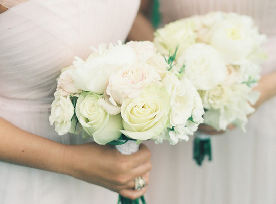 a bride holding s beautiful white bridal bouquet