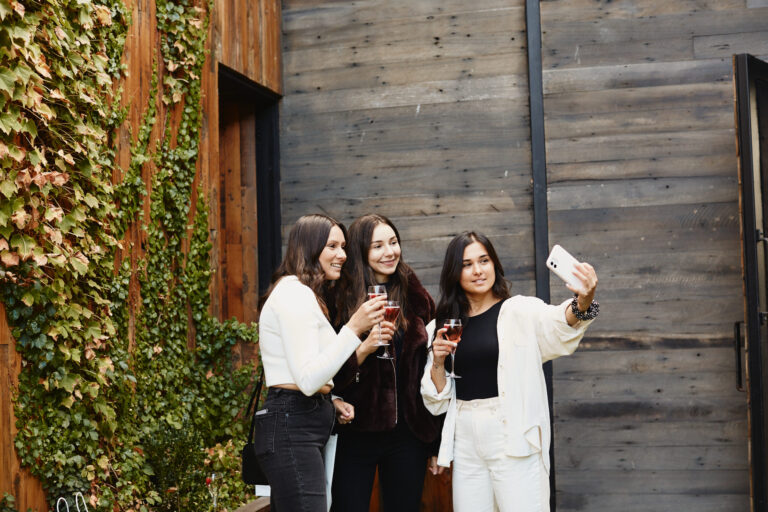 three women smiling happily at the camera
