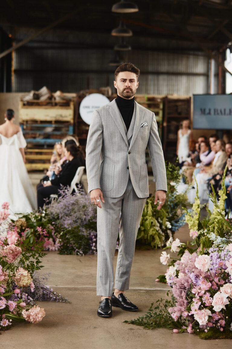 a groom wearing a gray wedding suit