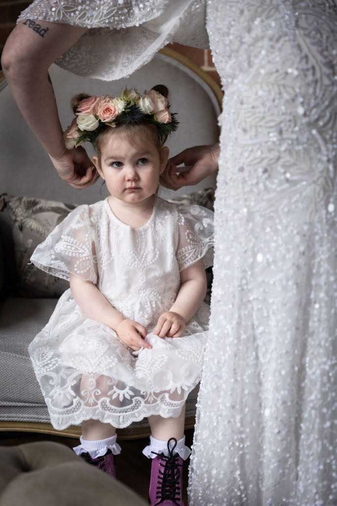a mum fixing the hair of a flower girl for a wedding moment captured by a sydney wedding photographer