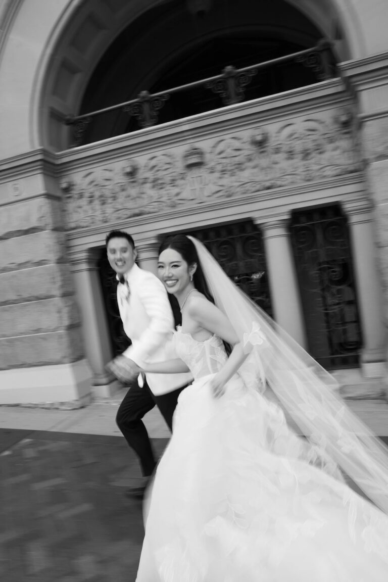 a bride and groom running and smiling, taken by a sydney wedding photographer, salt atelier