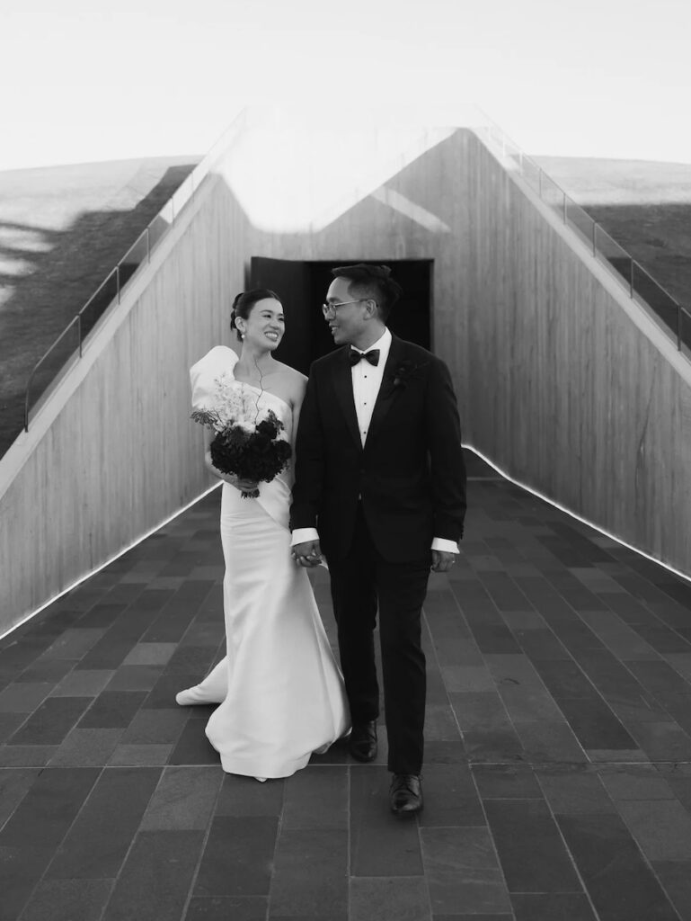 a couple standing in front of a sculpture