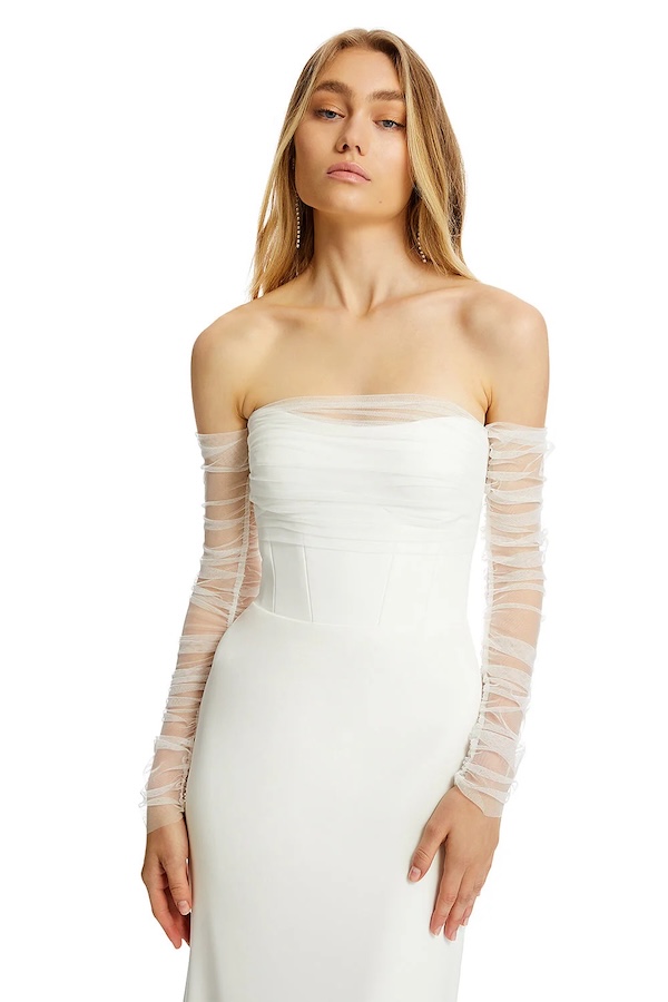 A bride in a long sleeve wedding dress with sheet sleeves