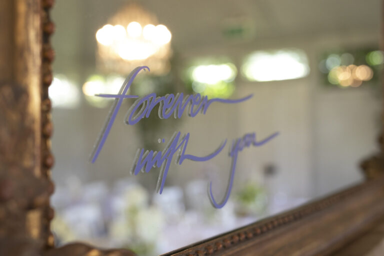 A mirror that has "Forever With You" written on it.