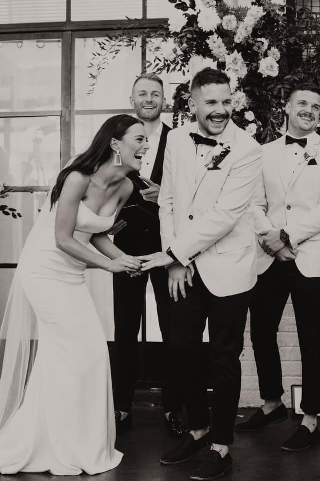 “Bride and groom sharing laughter during a heartfelt ceremony with Benn Stone, marriage celebrant Melbourne