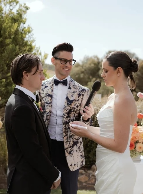 a marriage celebrant with a bride and groom