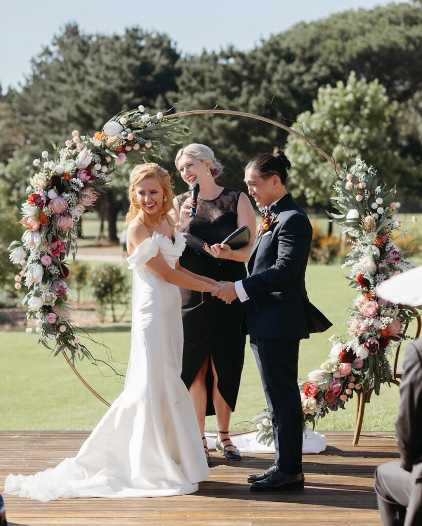 Melbourne marriage celebrant Abigail officiating a ceremony with a bride and groom