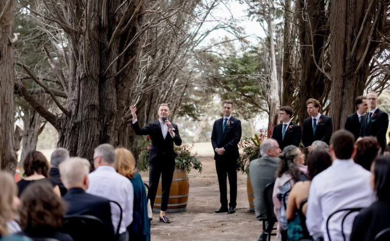 A melbourne wedding celebrant at the end of an aisle with a groom