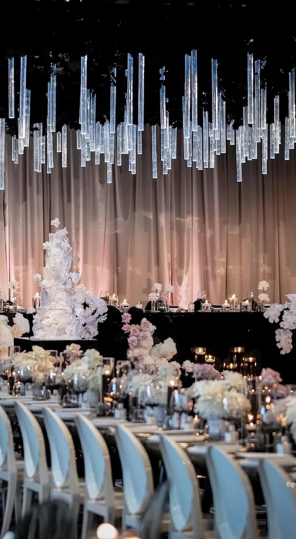 A moody wedding set up with hanging candles and soft lighting