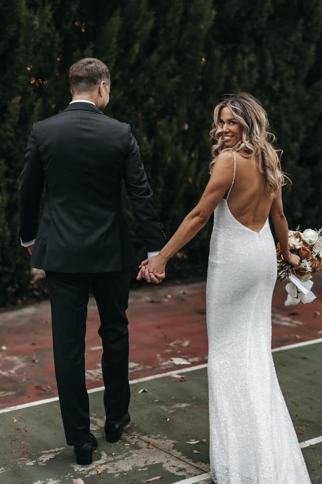 A couple holding hands.