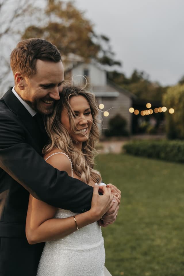 The groom hugging his bride.