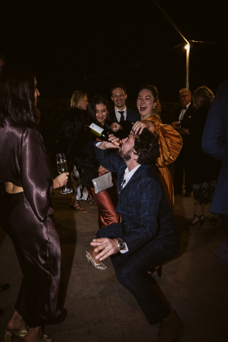 A man drinking a bottle of wine.