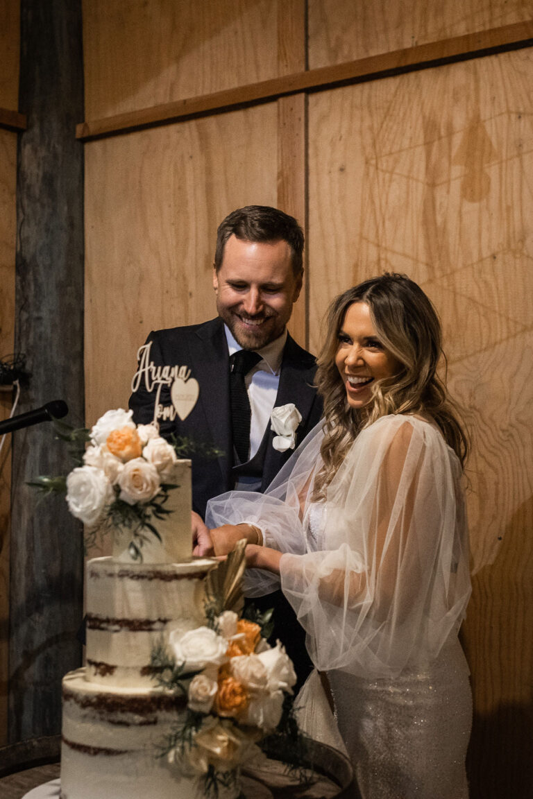 The newlyweds cutting their wedding cake.