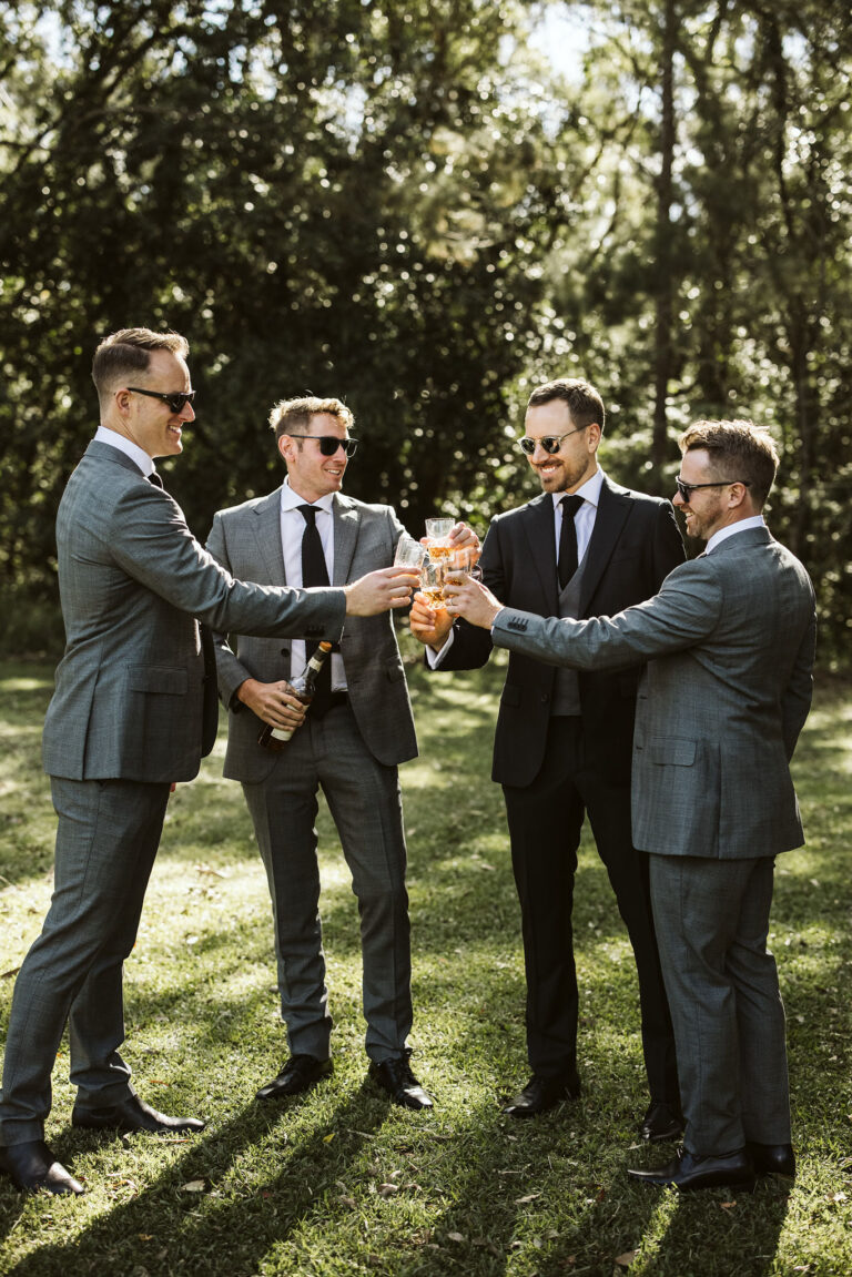 Four men toasting .