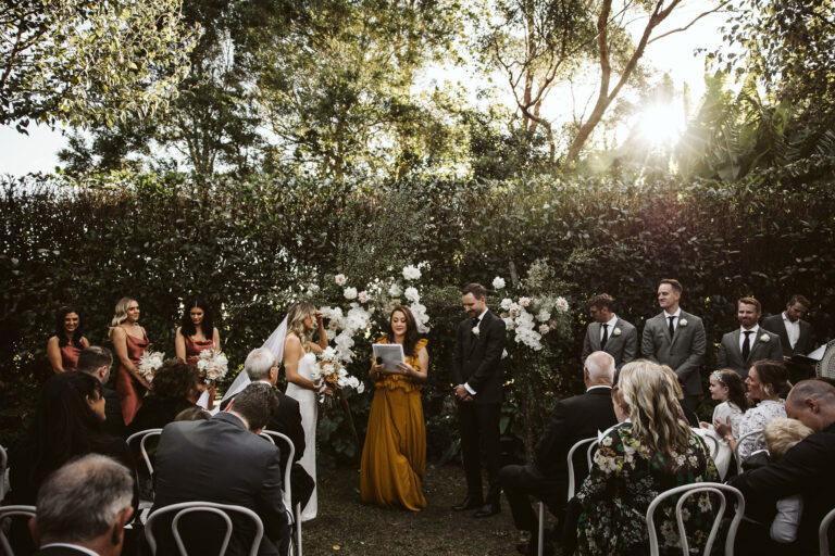 Wedding ceremony in a garden with beautiful flowers and decorations.