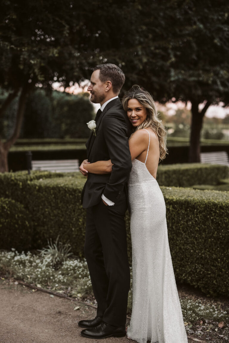 The bride hugging her groom.