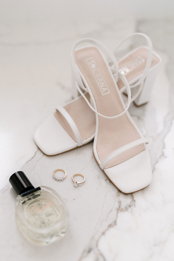 Wedding shoes, perfume and wedding rings.