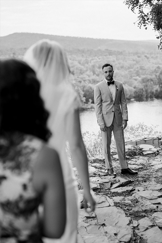 A groom looking at his bride.