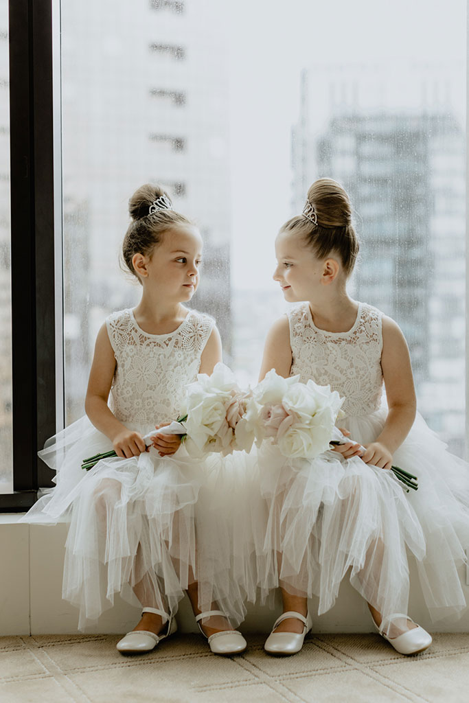 Twin girls in white dresses.