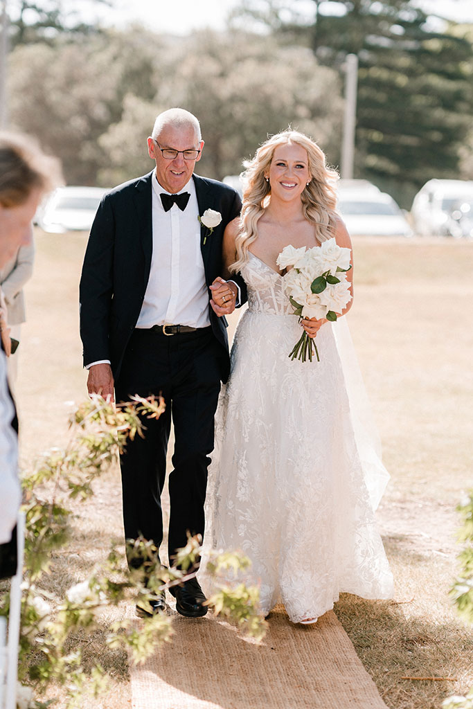 A man walking the bride down the aisle.
