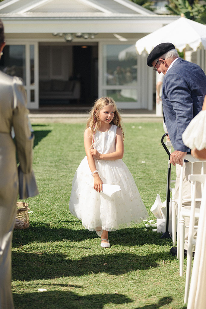 A little girl walking down the aisle.
