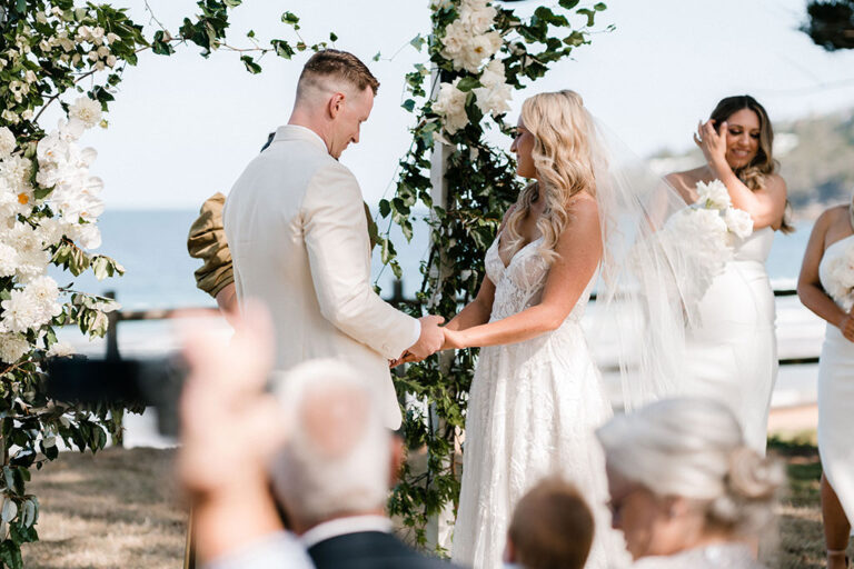A beautiful beach wedding ceremony with the ocean in the background.