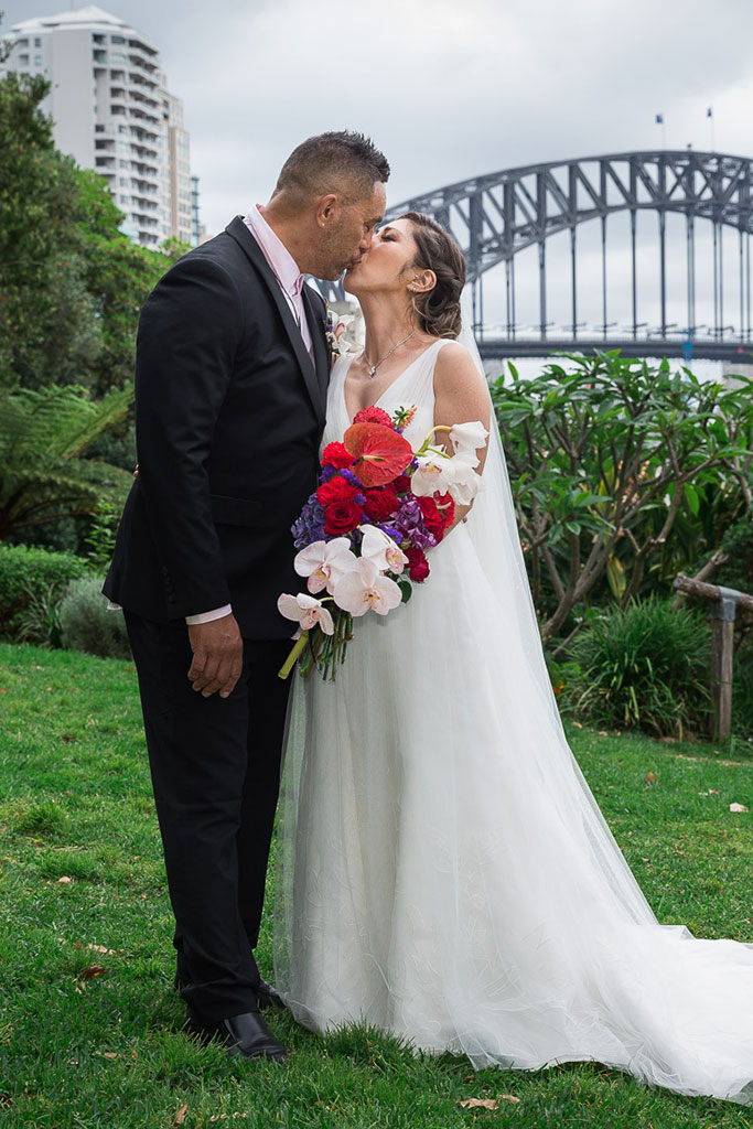 a photo of the bride and groom kissing on their wedding day
