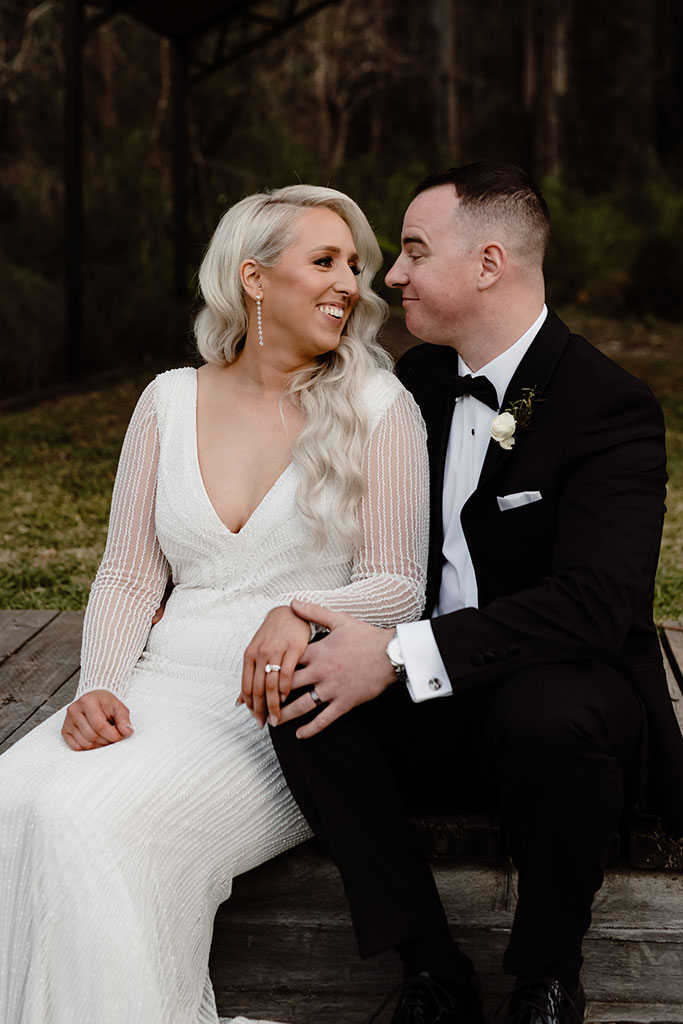 A bride and the groom holding hands.
