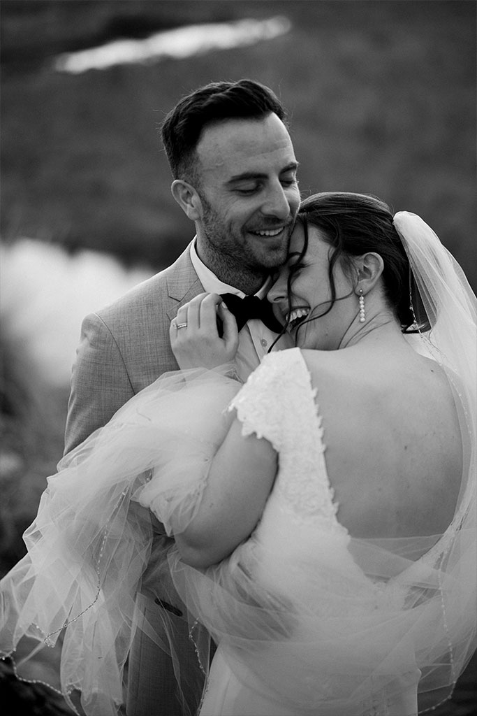 Newlyweds holding each other.