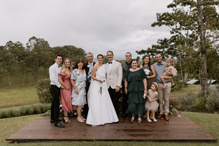 A couple posing with their family.