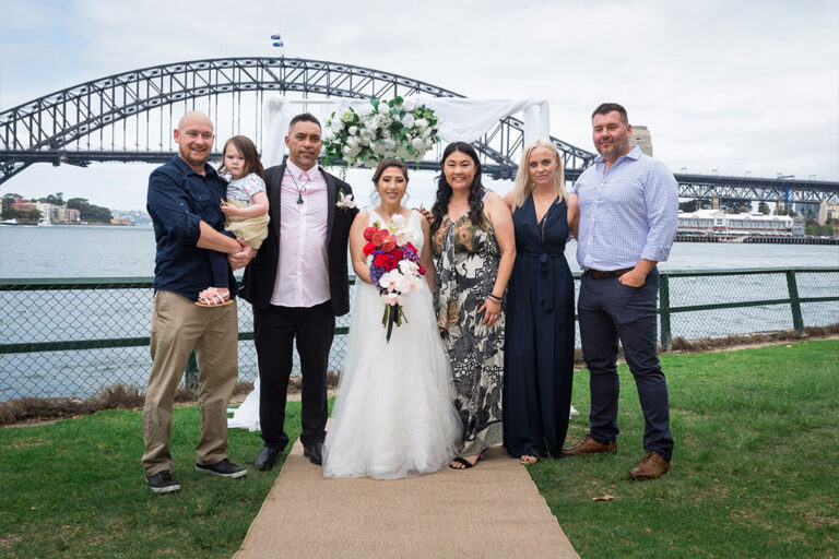 a photo of the bride and groom with their family and friends