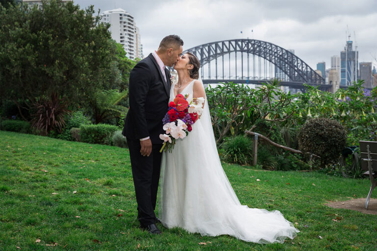 a photo of the bride and groom kissing on their wedding day