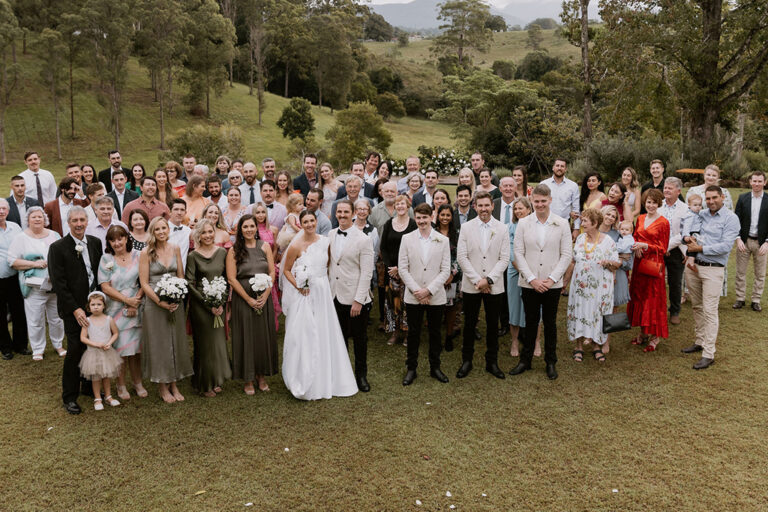A couple posing with their wedding guests.