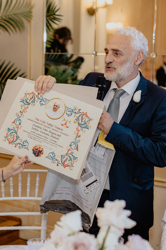 A man in a suit holding a certificate.