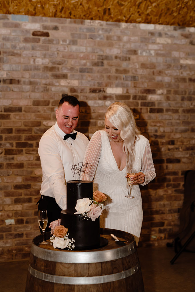 Newly weds cutting their wedding cake.