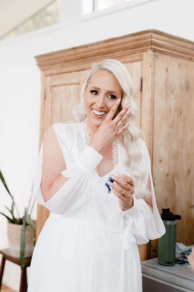 A woman wearing a wedding dress smiling.